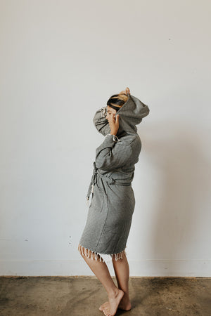 Woman wearing the Diamond Bathrobe in Charcoal with the hood up