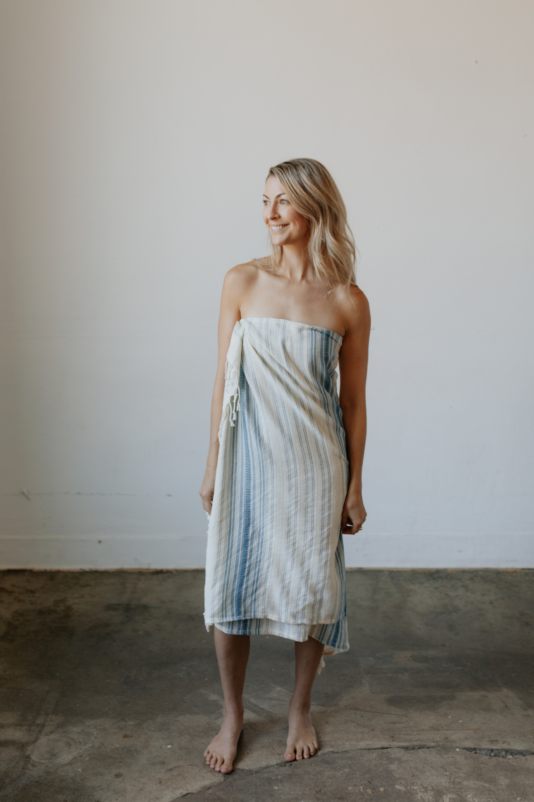 Woman wrapped in her Teal Ribbon towel