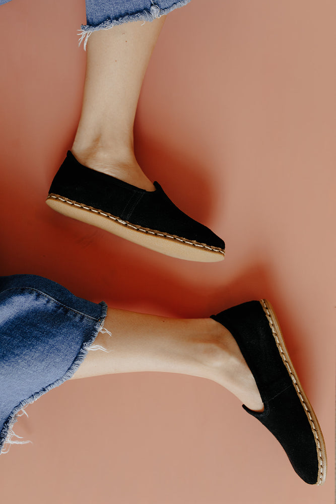 
            
                Load image into Gallery viewer, Neutral Suede Slip On in Black paired with jeans
            
        