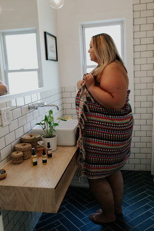 Woman wearing the Rainbow Pattern Towel as a towel wrap