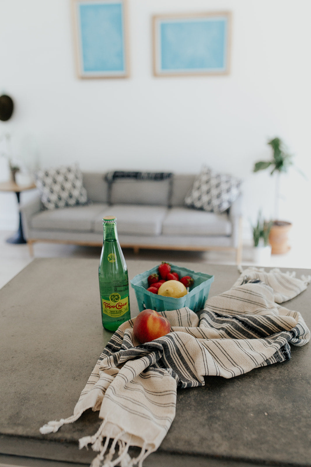 Ribbon Hand Towel in Charcoal on a coffee table