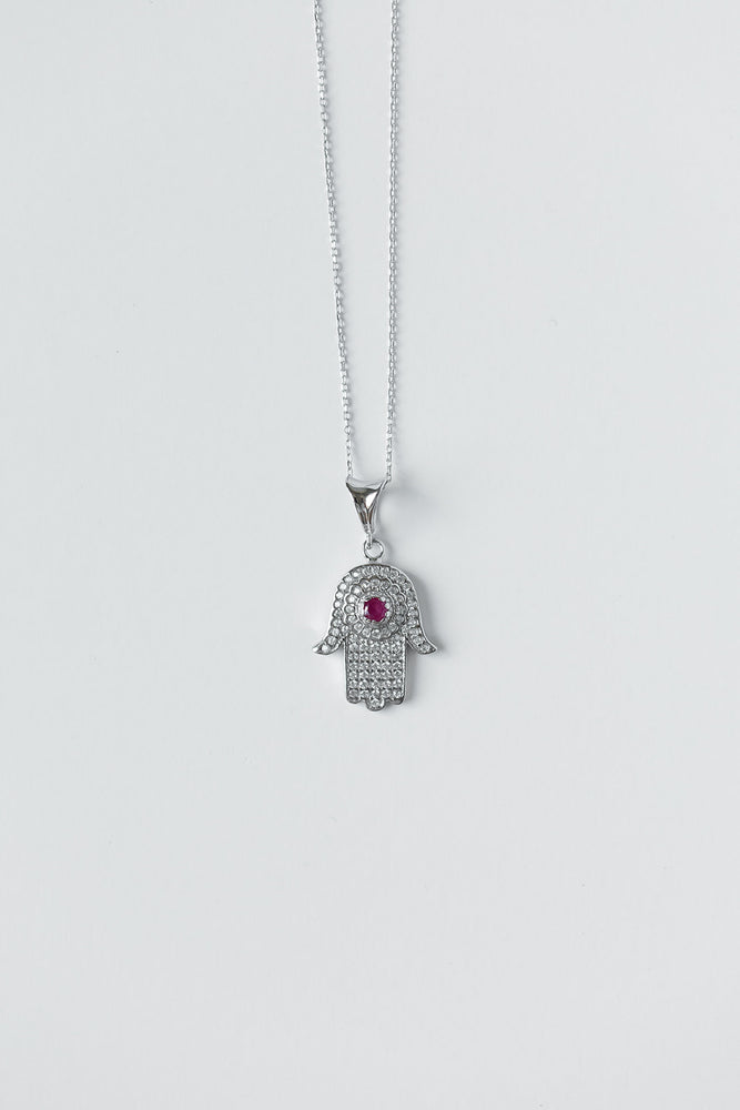 
            
                Load image into Gallery viewer, Hamsa + Evil Eye Silver Necklace with Magenta Gem
            
        
