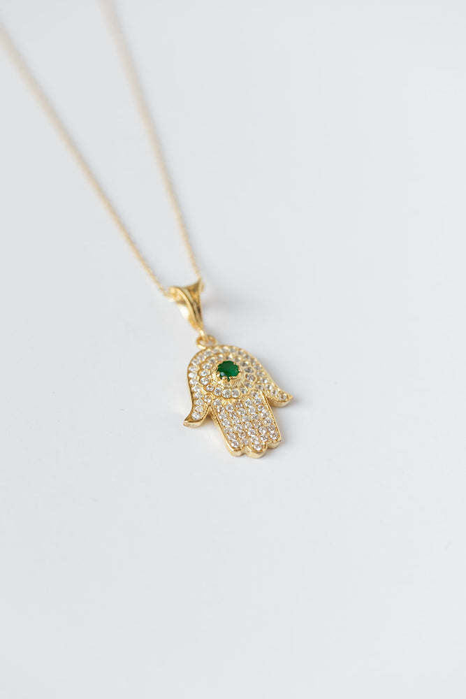 
            
                Load image into Gallery viewer, Hamsa + Evil Eye Gold Necklace with Emerald Gem
            
        
